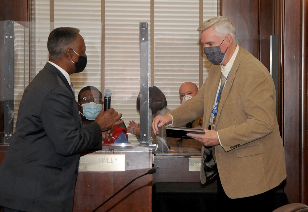 County Executive Frank White, Jr., presents Bob Kelly with a plaque honoring his retirement.